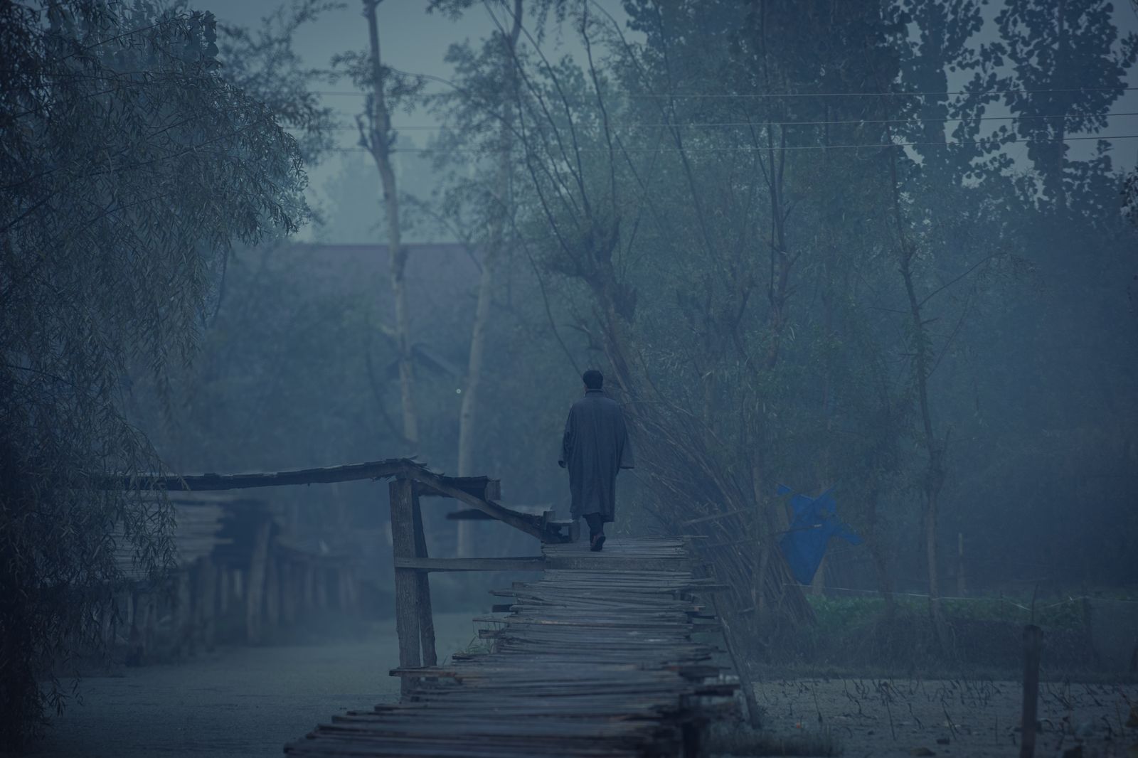 A tall pale figure in a dark coat