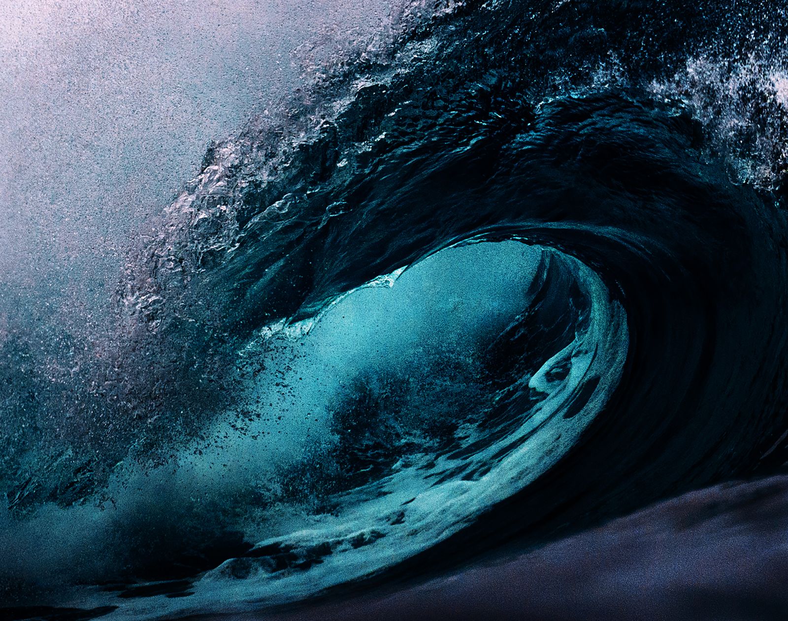 An enormous wave over a dark sea