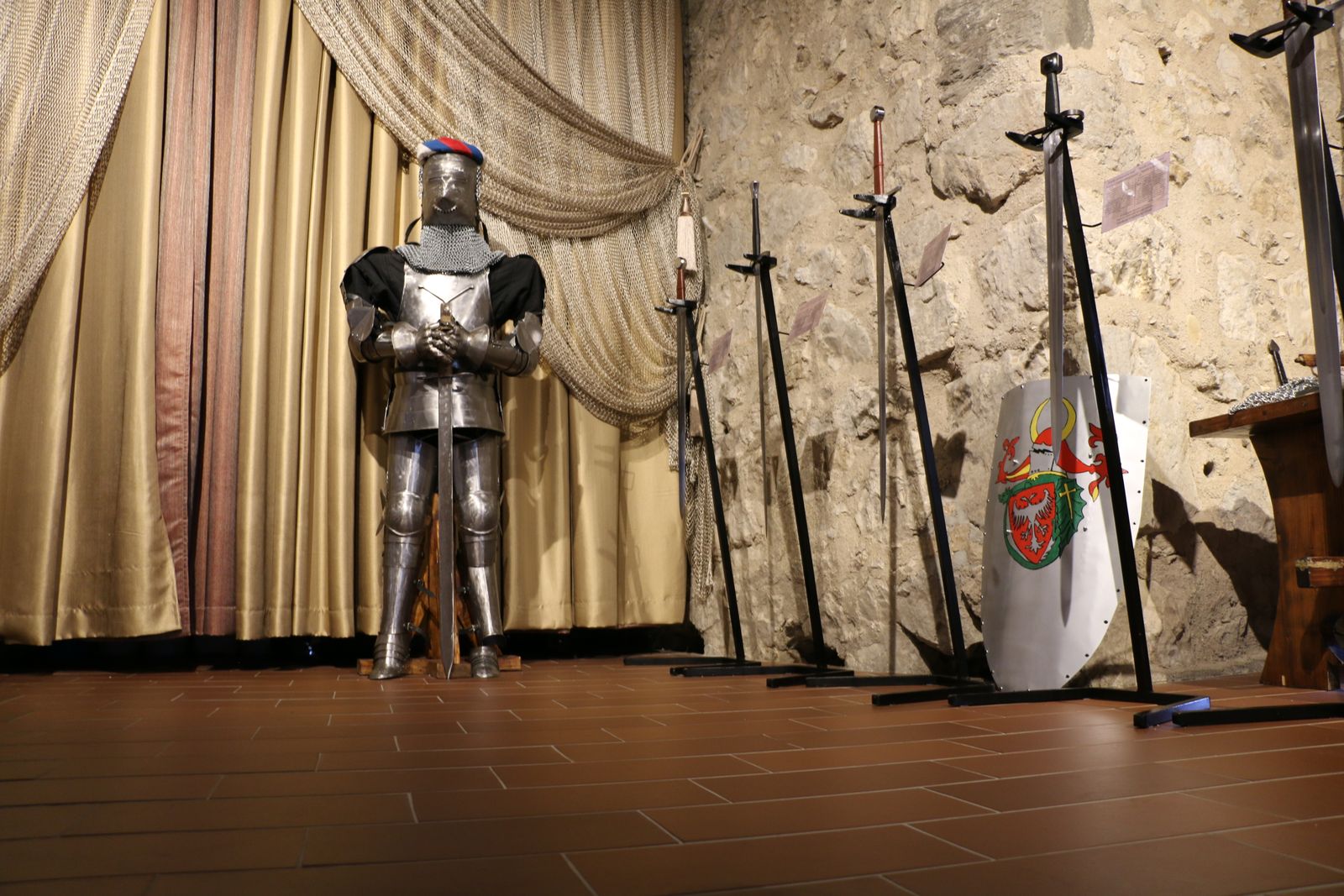 A sword and shield in candlelight