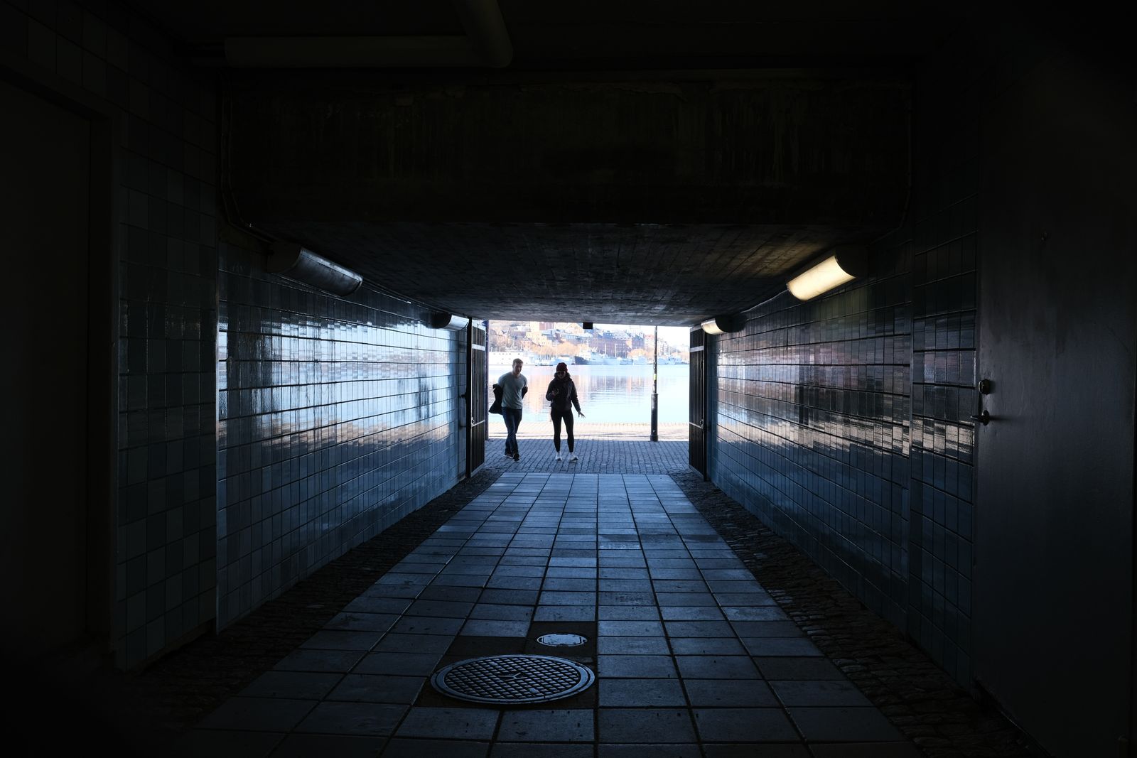 Two figures on a dark shore