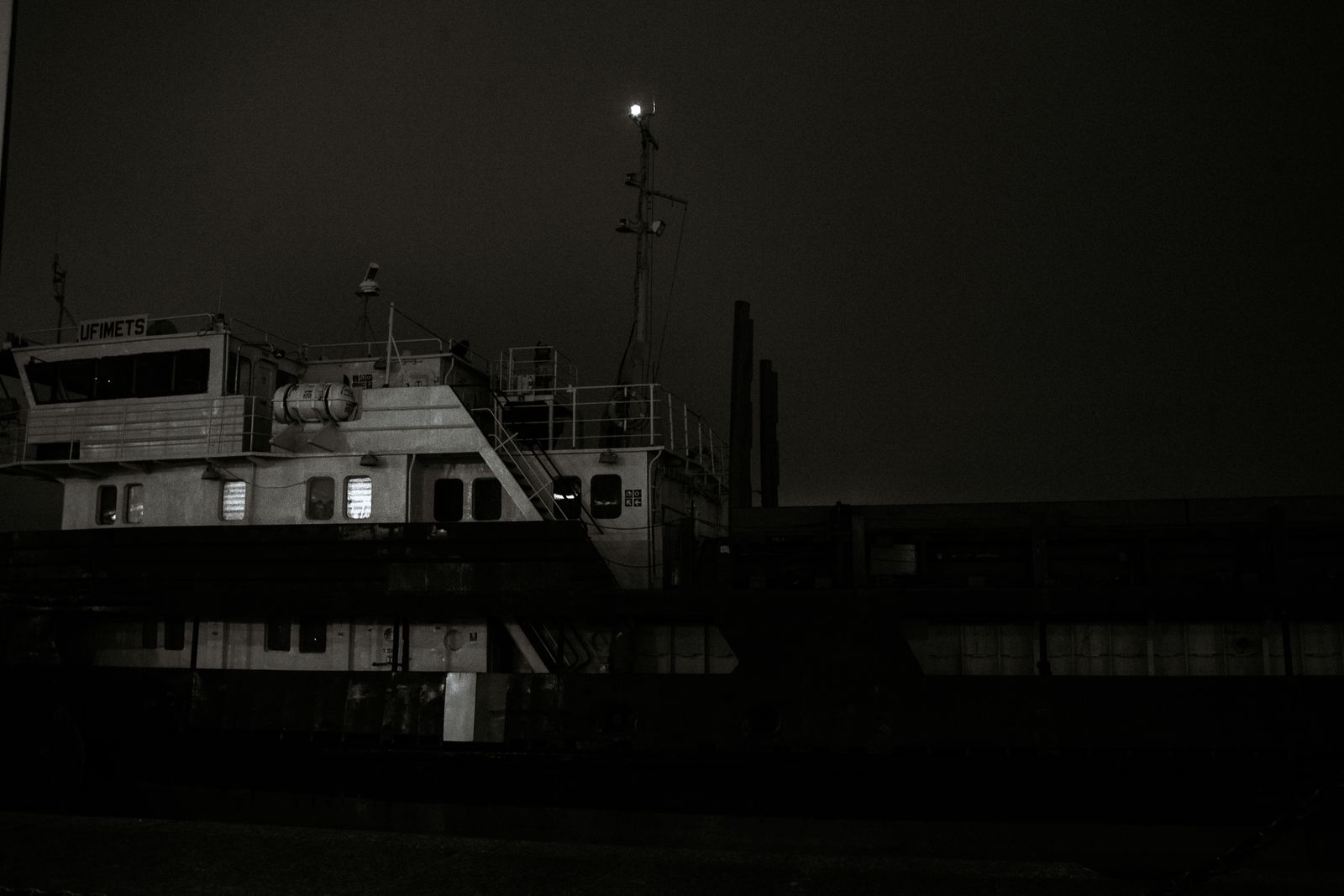 A dark sailing ship at night