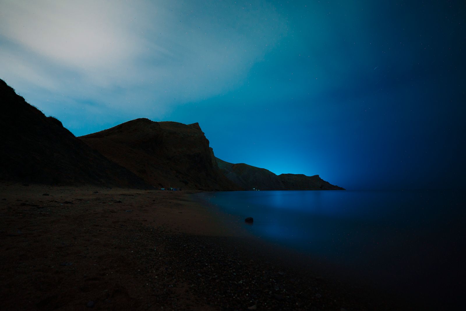 A sea cliff at night