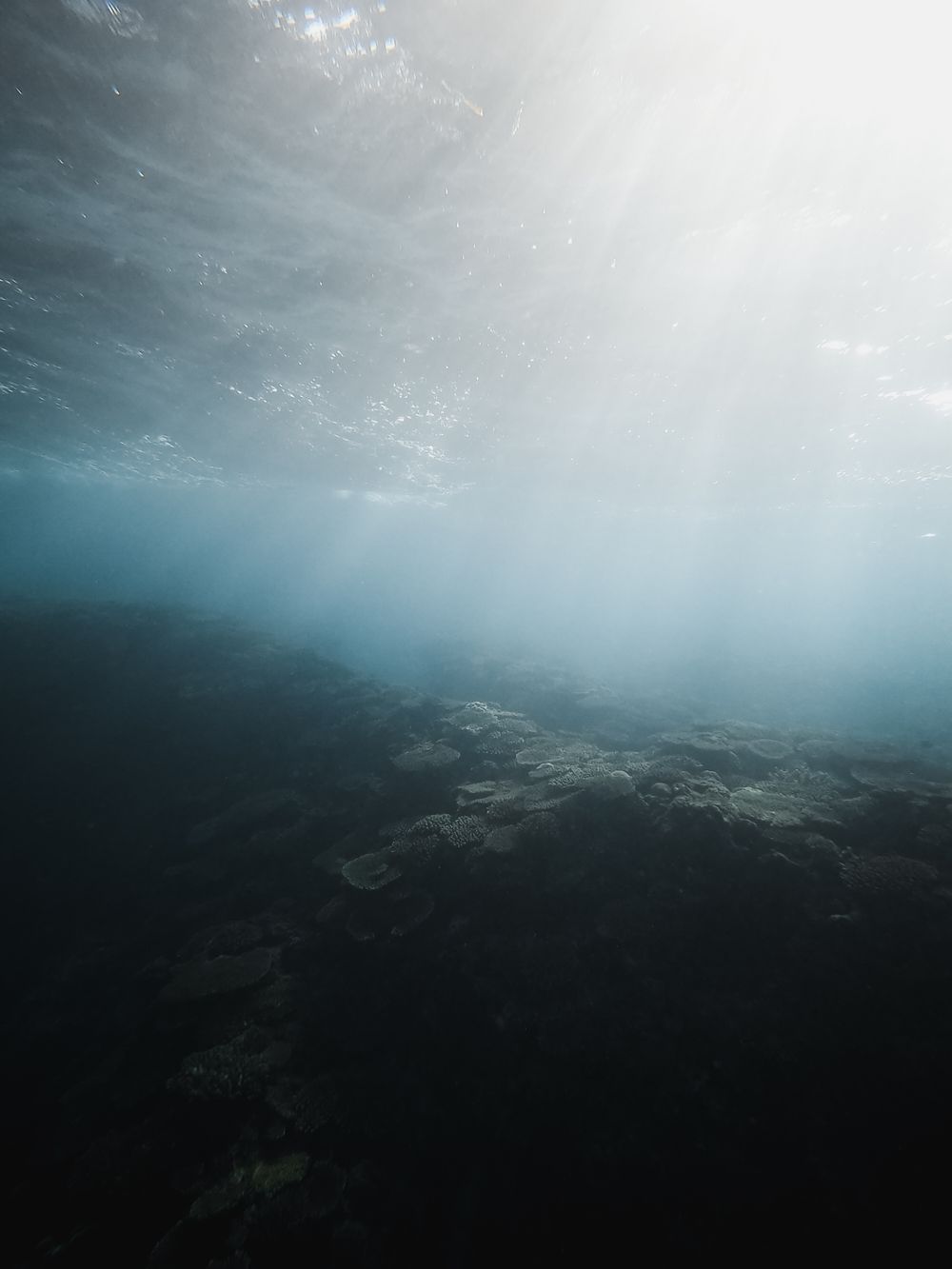 Turquoise light falling through deep water